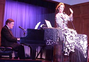 Marcovicci sits atop grand piano for dramatic effect [Photo by Tom Ineck]