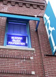 BMF neon sign illuminates office window [Photo by Tom Ineck]