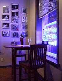 A corner table glows in the light of the neon sign. [Photo by Tom Ineck] 