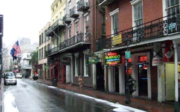 French Quarter streetscape features historic wrought-iron architecture and neon-lit bars. [Photo by Tom Ineck]