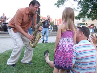 Vincelli serenades children in the audience. [Photo by Tom Ineck]